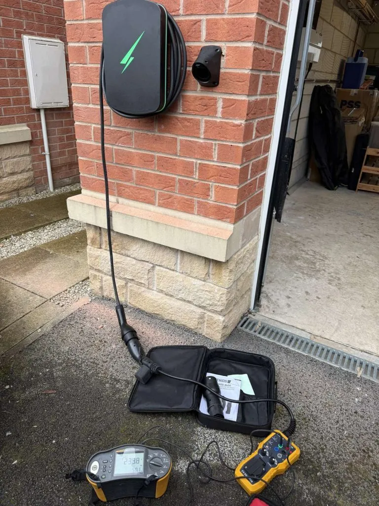 Hypervolt EV charger installed on a brick driveway pillar in Rotherham, with Megger MFT and Fluke test equipment during commissioning by MP Electrical