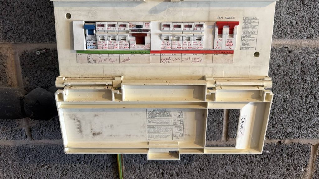 Old MEM consumer unit in a Rotherham home with a tripped MCB switch flipped down, a common cause of electrics that keep tripping.