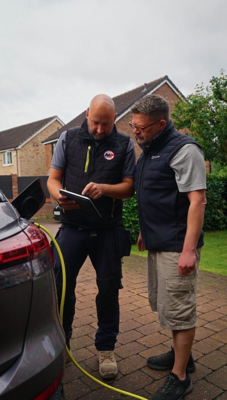 MP Electrical engineers commissioning a home EV charger on a driveway