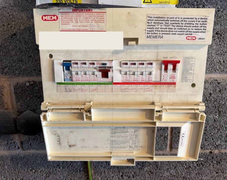 Older fuse board on a house wall that is due for replacement