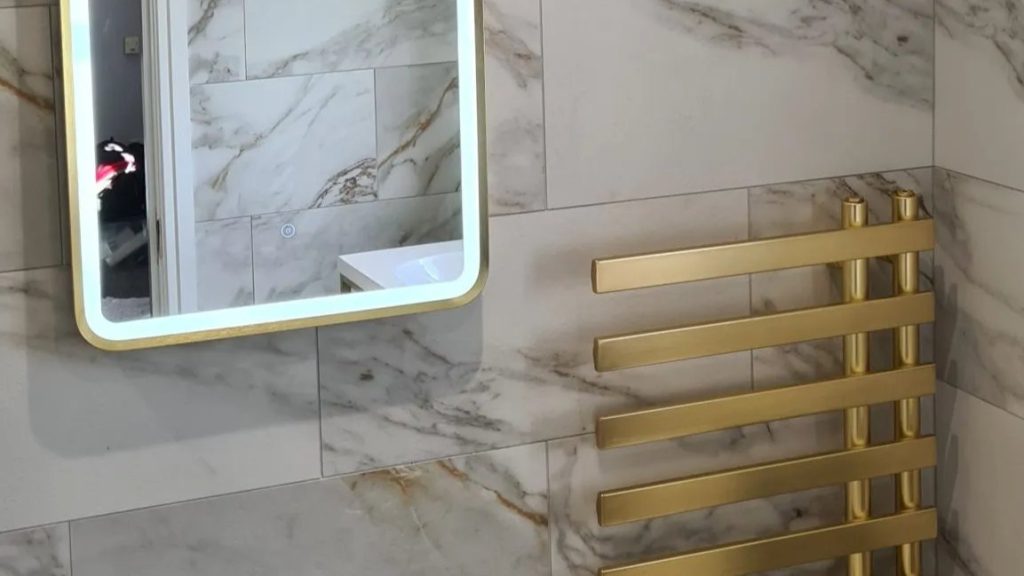 Modern bathroom with LED mirror and heated towel rail wired by MP Electrical, a Rotherham electrician