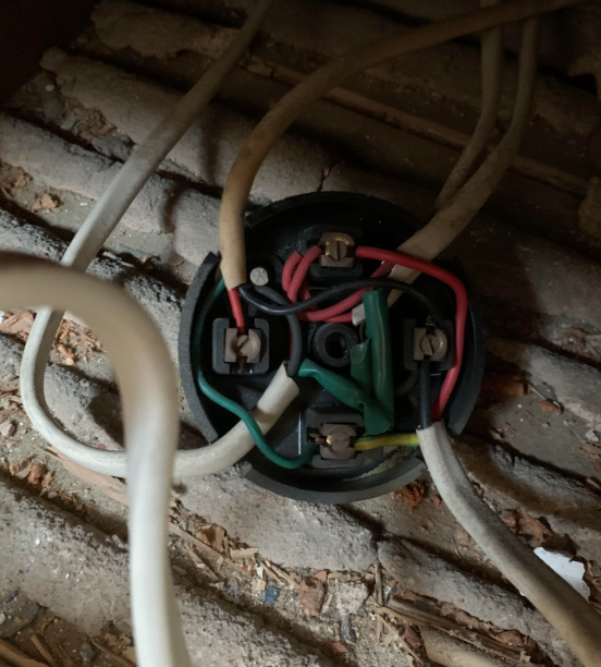 Junction box under the floorboards with a loose cable inside, the cause of an intermittent fault whenever the washing machine reached full spin